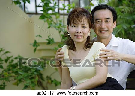 Mature couple sitting together, smiling View Large Photo Image Stock Photo - Mature couple sitting together, smiling . Fotosearch