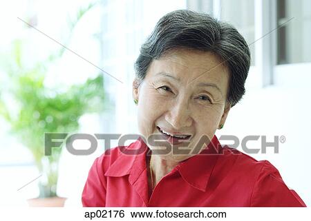 Mature woman smiling at camera View Large Photo Image Stock Photograph - Mature woman smiling at camera. Fotosearch