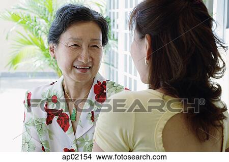 Mother and daughter having a conversation View Large Photo Image Picture - Mother and daughter having a conversation . Fotosearch
