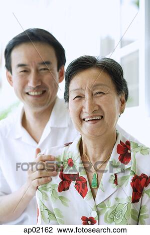 Mother and son smiling at camera View Large Photo Image Stock Image - Mother and son smiling at camera . Fotosearch