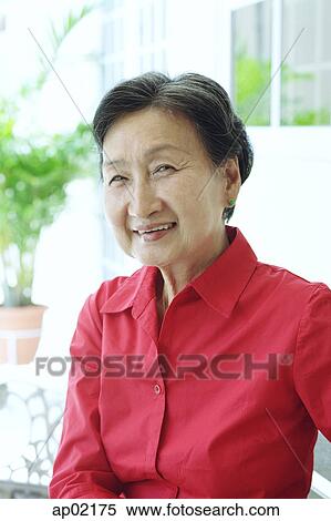 Portrait of a mature woman, smiling View Large Photo Image Stock Photography - Portrait of a mature woman, smiling . Fotosearch