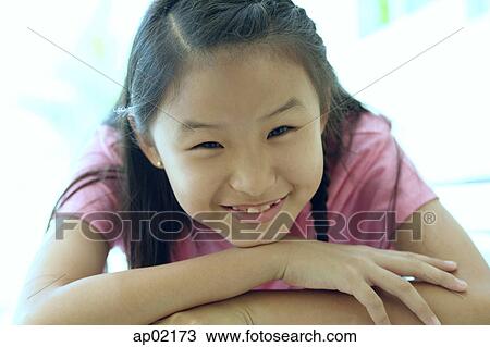 Portrait of a young girl, smiling View Large Photo Image Stock Image - Portrait of a young girl, smiling . Fotosearch