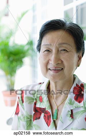 Stock Photo - Senior woman looking at camera, smiling . Fotosearch