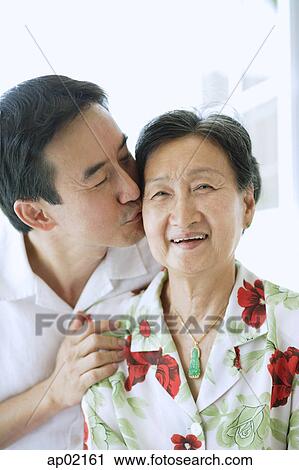 Son kissing mother on cheek View Large Photo Image Stock Image - Son kissing mother on cheek . Fotosearch
