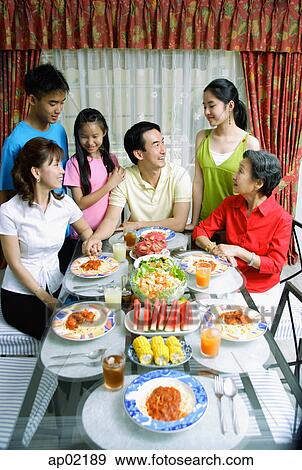 Three generation family at dining table View Large Photo Image Stock Photo - Three generation family at dining table . Fotosearch