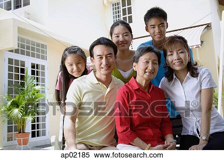 Stock Photography - Three generation family, looking at camera, portrait . Fotosearch