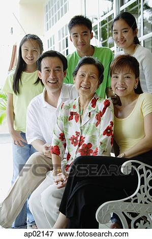 Three generation family smiling at camera View Large Photo Image Stock Photo - Three generation family smiling at camera . Fotosearch