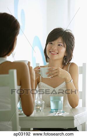 Two women in cafe, having coffee View Large Photo Image Stock Image - Two women in cafe, having coffee . Fotosearch