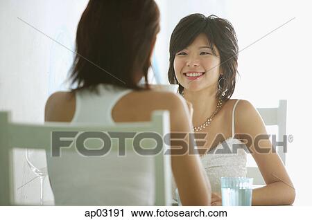 Two women in cafe, sitting face to face View Large Photo Image Stock Image - Two women in cafe, sitting face to face . Fotosearch
