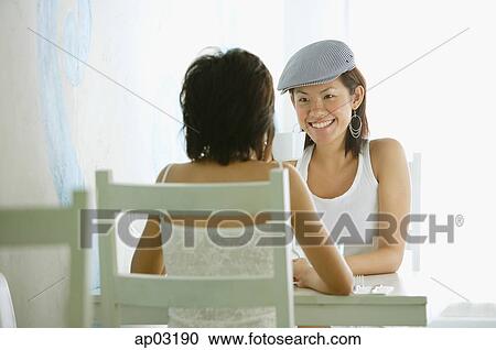 Two women in cafe View Large Photo Image Stock Image - Two women in cafe. Fotosearch