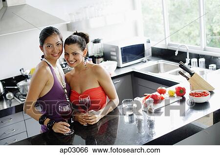 Two women in kitchen View Large Photo Image Stock Photograph - Two women in kitchen . Fotosearch