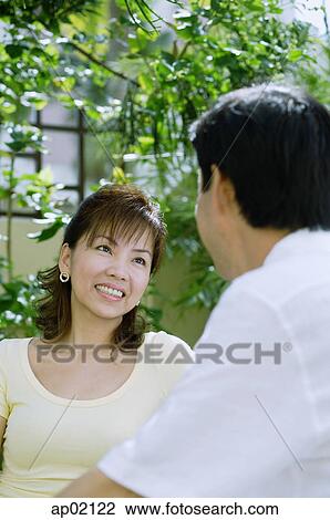 Wife looking at husband, smiling View Large Photo Image Stock Image - Wife looking at husband, smiling . Fotosearch