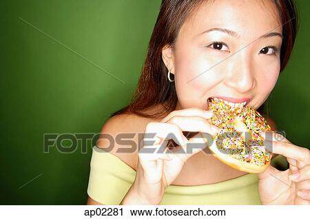 Woman eating donut View Large Photo Image Stock Image - Woman eating donut . Fotosearch