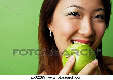 Woman eating green apple View Large Photo Image Stock Photo - Woman eating green apple . Fotosearch