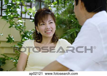 Woman facing man, smiling View Large Photo Image Stock Image - Woman facing man, smiling . Fotosearch