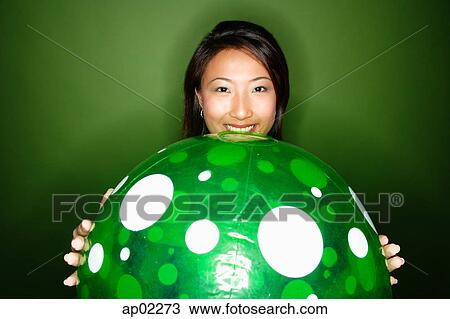 Woman holding big green inflated ball View Large Photo Image Stock Image - Woman holding big green inflated ball . Fotosearch