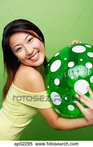 Woman hugging inflatable ball, smiling at camera View Large Photo Image Stock Photography - Woman hugging inflatable ball, smiling at camera . Fotosearch