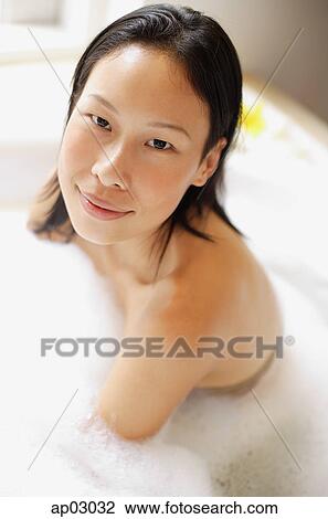 Woman in bathtub, covered with soap suds, smiling View Large Photo Image Stock Image - Woman in bathtub, covered with soap suds, smiling. Fotosearch
