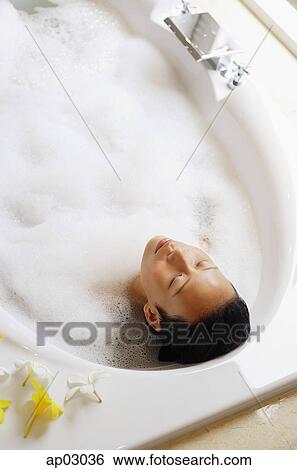 Woman in bathtub, eyes closed, high angle view View Large Photo Image Stock Photograph - Woman in bathtub, eyes closed, high angle view . Fotosearch