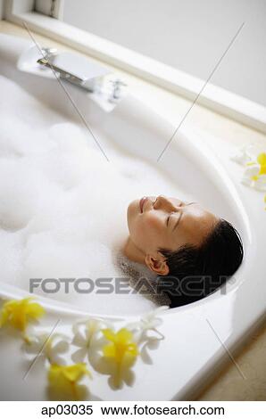 Woman in bathtub, eyes closed View Large Photo Image Stock Photography - Woman in bathtub, eyes closed. Fotosearch