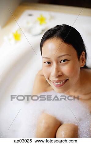 Woman in bathtub, smiling at camera View Large Photo Image Stock Photography - Woman in bathtub, smiling at camera . Fotosearch