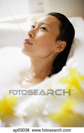 Woman in bathtub, taking bubble bath, looking away View Large Photo Image Stock Photo - Woman in bathtub, taking bubble bath, looking away. Fotosearch