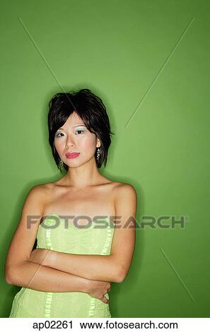 Woman in green dress, arms crossed View Large Photo Image Stock Image - Woman in green dress, arms crossed . Fotosearch