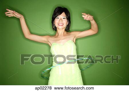 Woman in green strapless dress using hoola hoop View Large Photo Image Stock Photo - Woman in green strapless dress using hoola hoop . Fotosearch