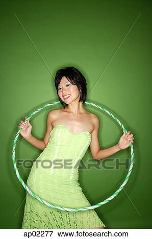 Woman in green strapless dress, with hoola hoop View Large Photo Image Stock Photo - Woman in green strapless dress, with hoola hoop. Fotosearch
