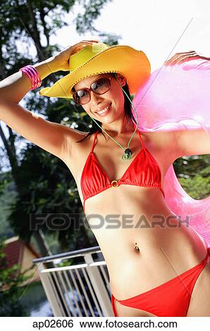 Woman in red bikini, sunglasses and hat, smiling View Large Photo Image Stock Photograph - Woman in red bikini, sunglasses and hat, smiling . Fotosearch