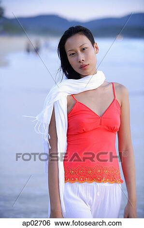Stock Photograph - Woman in red top and white scarf, standing, looking at camera . Fotosearch