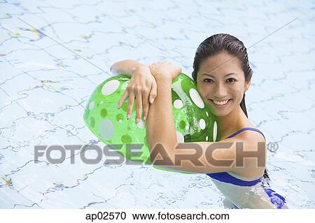 Woman in swimming pool, hugging beach ball View Large Photo Image Stock Image - Woman in swimming pool, hugging beach ball. Fotosearch