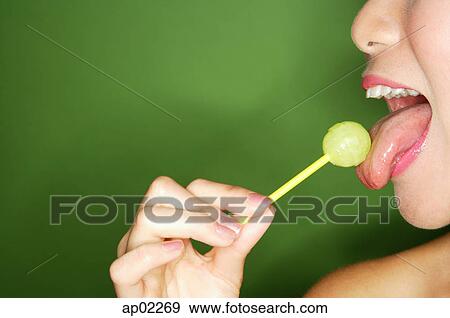 Woman licking lollipop, side view View Large Photo Image Stock Photo - Woman licking lollipop, side view . Fotosearch