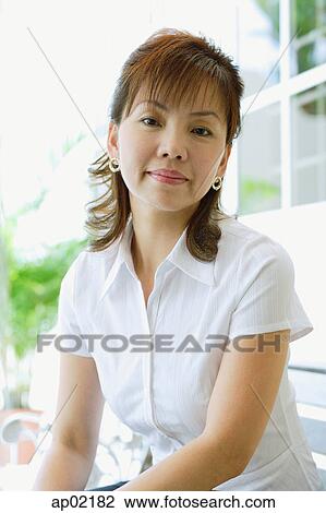 Stock Image - Woman looking at camera, portrait. Fotosearch