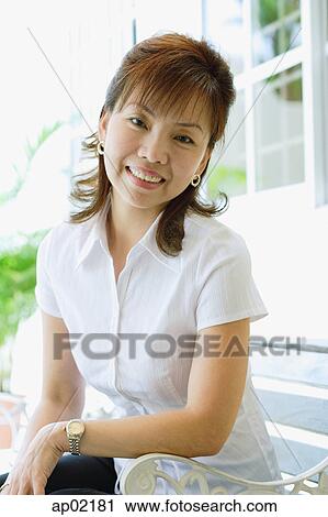Stock Image - Woman looking at camera, smiling . Fotosearch