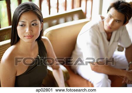 Stock Image - Woman looking away, man next to her, looking at her . Fotosearch