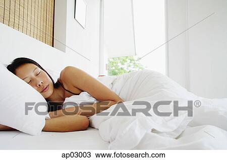 Woman lying in bed, sleeping View Large Photo Image Stock Image - Woman lying in bed, sleeping. Fotosearch