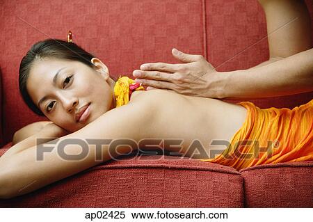 Woman lying on sofa getting a massage View Large Photo Image Stock Photography - Woman lying on sofa getting a massage . Fotosearch