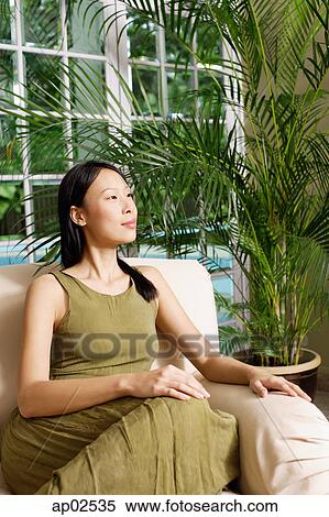 Woman on arm chair, looking away View Large Photo Image Stock Photography - Woman on arm chair, looking away. Fotosearch