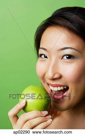 Woman preparing to bite into green apple View Large Photo Image Stock Image - Woman preparing to bite into green apple . Fotosearch