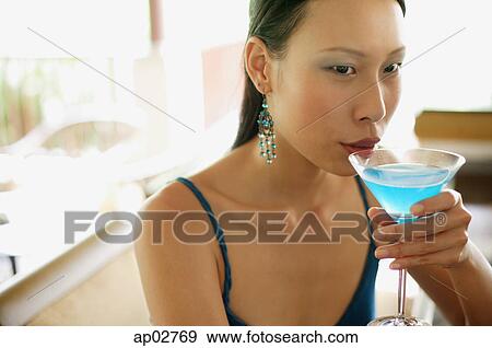 Woman sipping cocktail View Large Photo Image Stock Photo - Woman sipping cocktail . Fotosearch