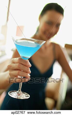 Woman sitting at bar counter, holding cocktail, selective focus View Large Photo Image Stock Photo - Woman sitting at bar counter, holding cocktail, selective focus . Fotosearch