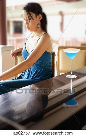 Woman sitting at bar counter View Large Photo Image Stock Photo - Woman sitting at bar counter . Fotosearch