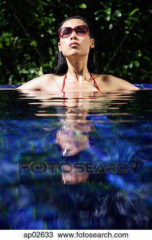 Woman sitting in swimming pool, head above water View Large Photo Image Stock Image - Woman sitting in swimming pool, head above water . Fotosearch