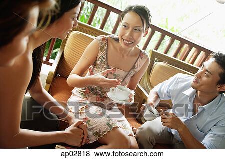 Woman sitting with friends having coffee View Large Photo Image Stock Photo - Woman sitting with friends having coffee . Fotosearch