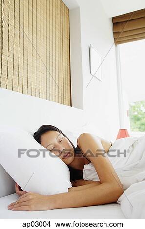 Woman sleeping in bed View Large Photo Image Picture - Woman sleeping in bed. Fotosearch