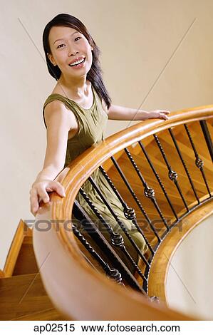 Woman standing on staircase, looking at camera View Large Photo Image Stock Photography - Woman standing on staircase, looking at camera . Fotosearch