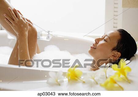 Woman taking a bath, washing leg View Large Photo Image Stock Image - Woman taking a bath, washing leg . Fotosearch