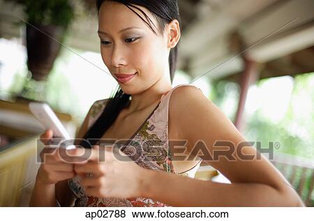 Woman using mobile phone, text messaging View Large Photo Image Stock Photo - Woman using mobile phone, text messaging . Fotosearch
