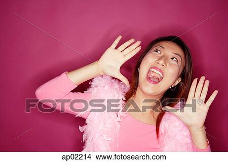Woman wearing feather boa, shouting View Large Photo Image Picture - Woman wearing feather boa, shouting . Fotosearch